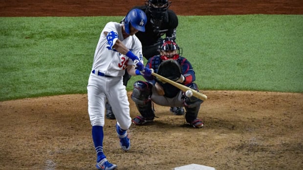 Oct 13, 2020; Arlington, Texas, USA; Los Angeles Dodgers center fielder Cody Bellinger (35) hits a triple against the Atlanta Braves during the ninth inning in game two of the 2020 NLCS at Globe Life Field. Mandatory Credit: Jerome Miron-USA TODAY Sports